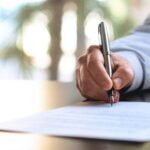 Businessman Signing An Official Document