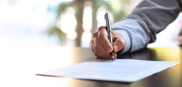 Businessman Signing An Official Document